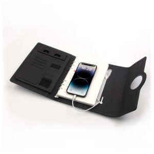 Smartphone charging wirelessly on top of Multifunctional Notebook 2.0 cover