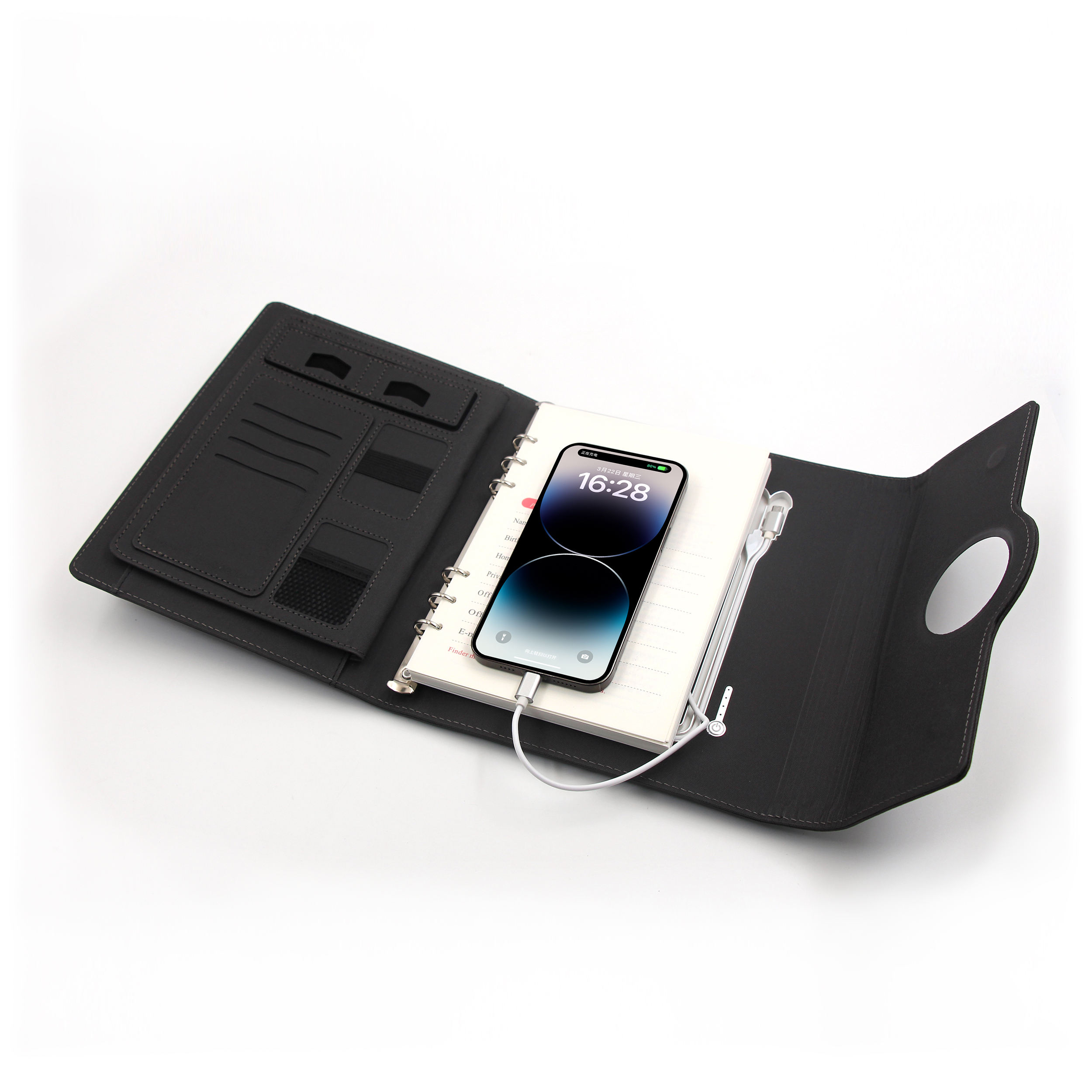 Smartphone charging wirelessly on top of Multifunctional Notebook 2.0 cover