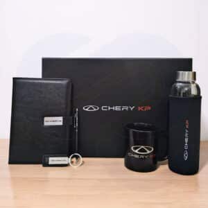 Prime executive gift box with leather notebook, black mug, glass bottle, pen, and keychain from CGS
