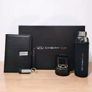 Prime executive gift box with leather notebook, black mug, glass bottle, pen, and keychain from CGS